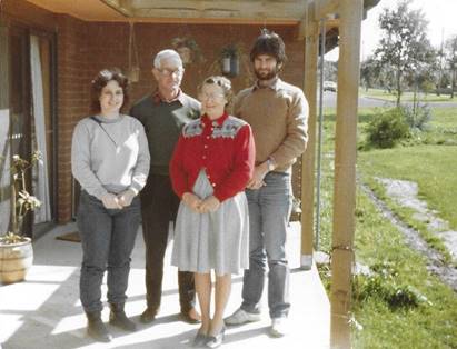 A group of people standing on a porch
Description automatically generated